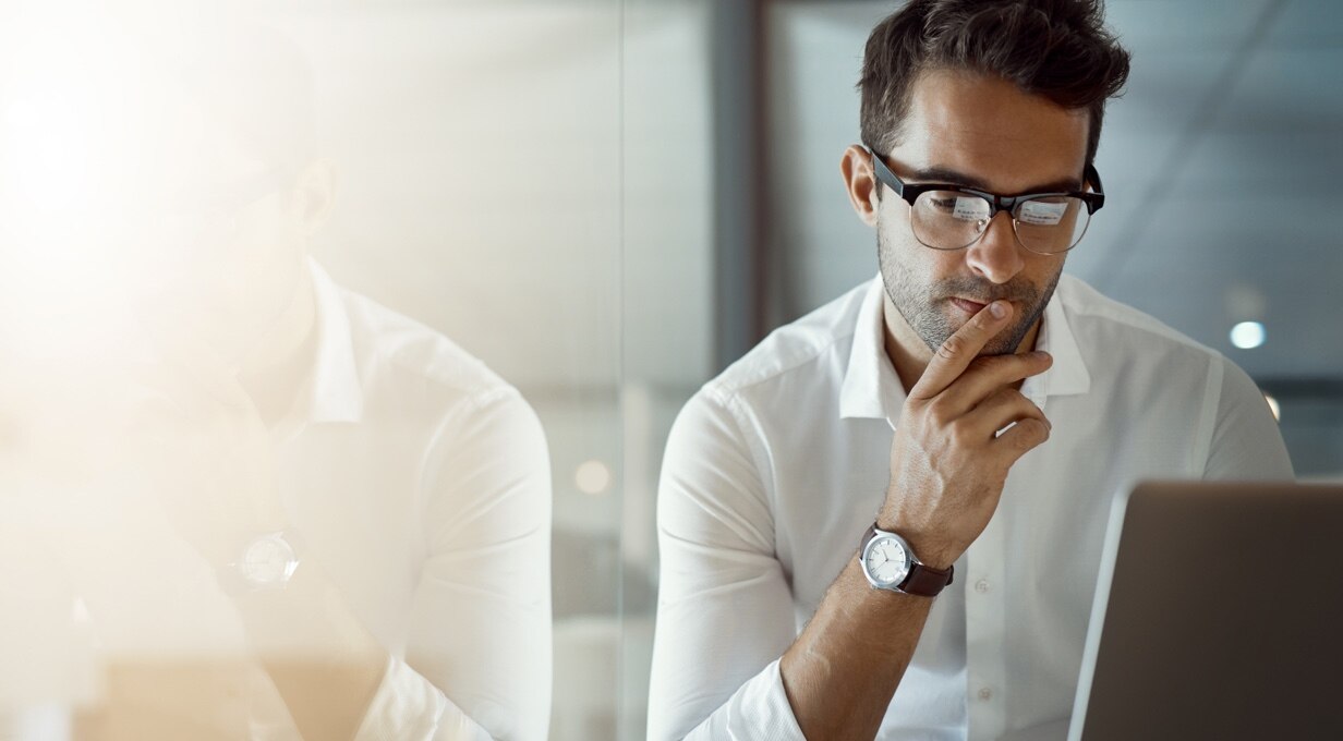 A businessperson works at a computer.