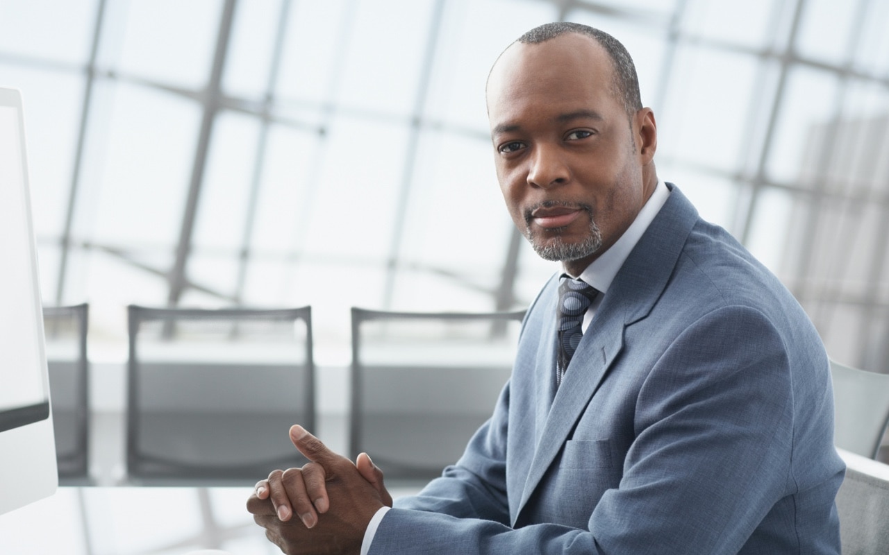 An advisor looks confidently into the camera.