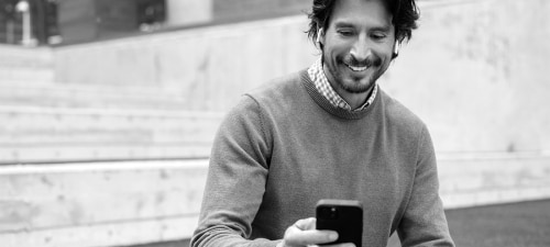 Image of a man looking at his phone.