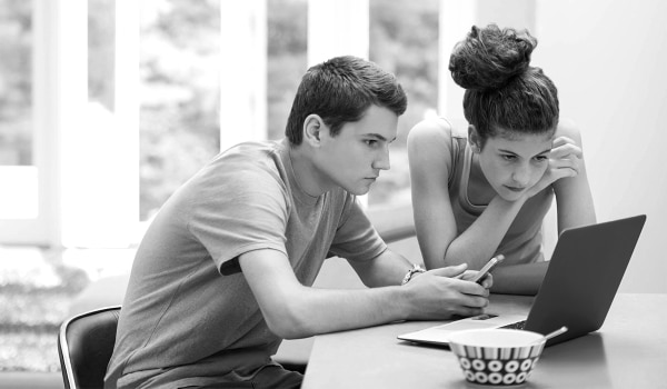 Young adults researching on a laptop