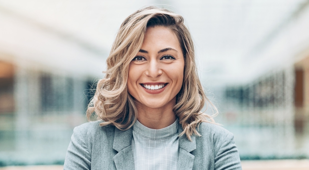 A businessperson smiles.