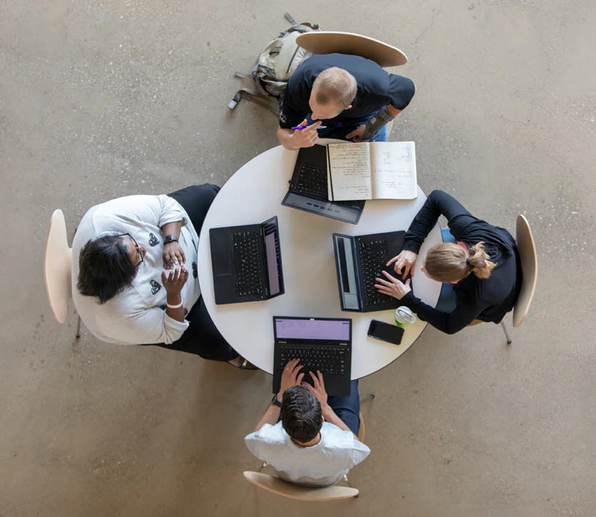 4 people sitting at a round table