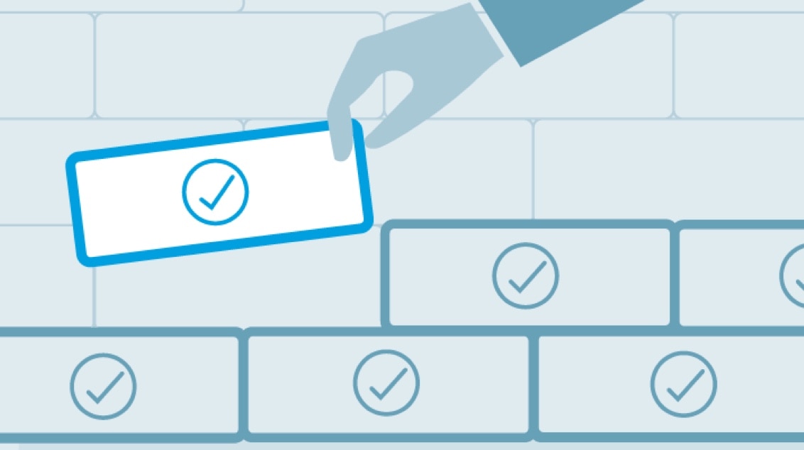 Illustration of a hand placing a brick among other bricks.