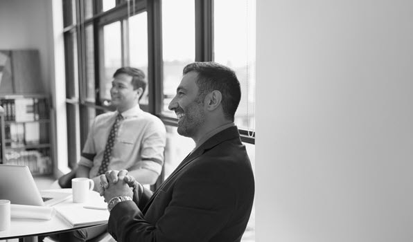 men smiling at conference table