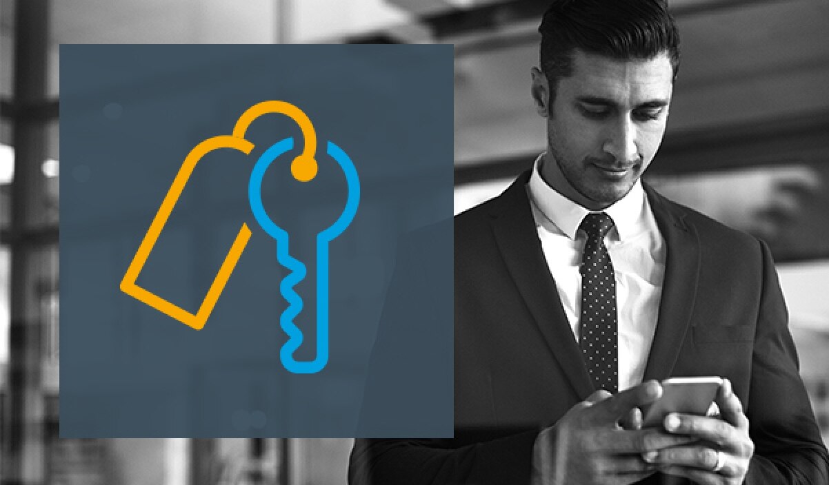 An icon of a set of keys on a photo of an advisor using a cell phone.