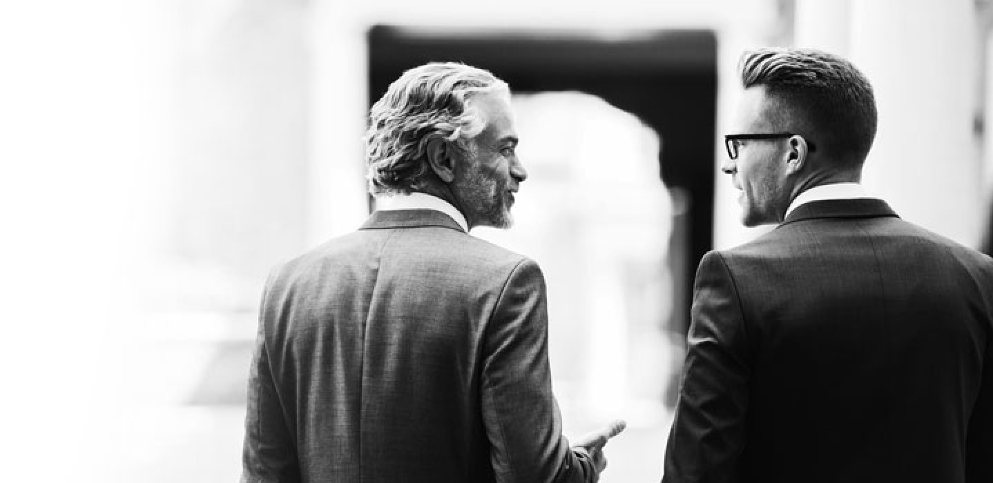 Two men in suits talking