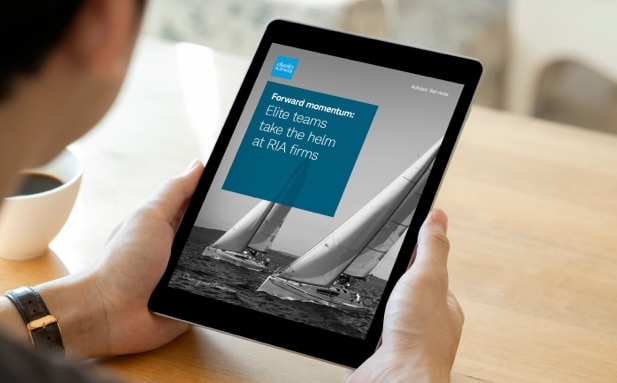A person holds a tablet displaying the “Elite Teams Take the Helm at RIA Firms” white paper.
