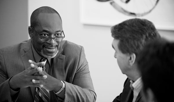 Male advisor consulting two clients.