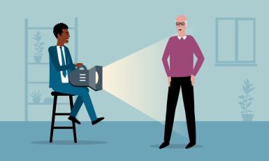 A male shining a spotlight on another male